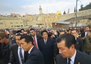 Japanese Prime Minister Shinzo Abe, center, and his wife, Akie, visit the Western Wall in Jerusalem yesterday.