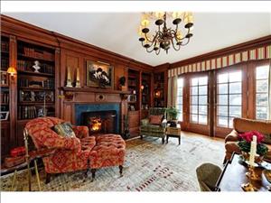 The                                                          wood-paneled                                                          library with                                                          fireplace.