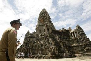 In this photo taken on June 28, 2012, a police officer stands guard at Cambodia's famed Angkor Wat temple complex in Siem Reap province.